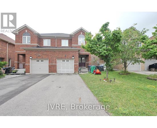 A large brick house with a driveway in front.