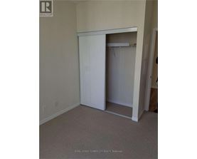 A white closet with a door open in a room.