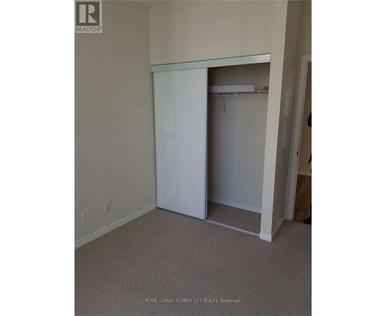 A white closet with a door open in a room.