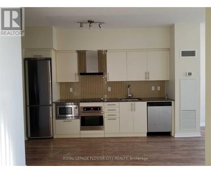 A kitchen with white cabinets and a tiled backsplash.