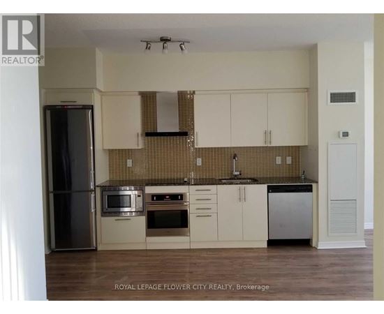 A kitchen with white cabinets and a tiled backsplash.