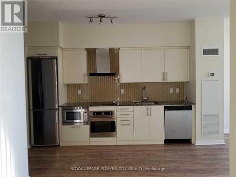 A kitchen with white cabinets and a tiled backsplash.