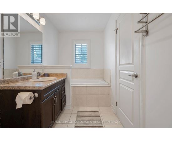 A bathroom with a marble countertop and a white door.