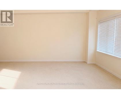 A room with a window and a wall with a logo that says REALTOR.