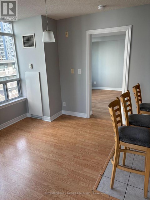 A room with a wooden floor and a chair.