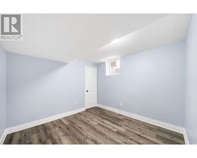 A room with a door and a window with a white frame.