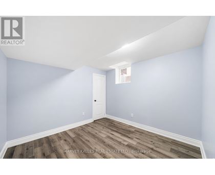 A room with a door and a window with a white frame.