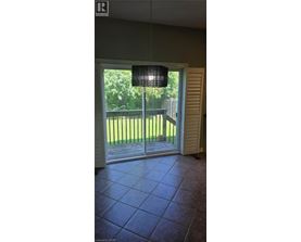 A room with a sliding glass door leading to a backyard.