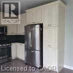 A kitchen with a refrigerator and cabinets.