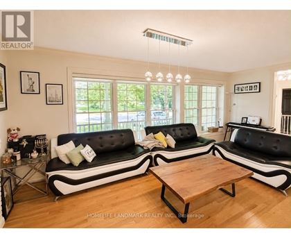 A living room with a black and white sofa and a wooden coffee table.