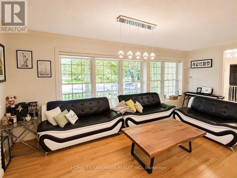 A living room with a black and white sofa and a wooden coffee table.