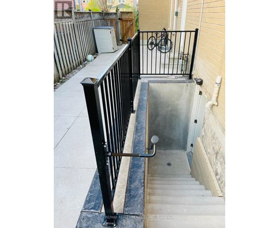 A black metal railing on a concrete staircase.