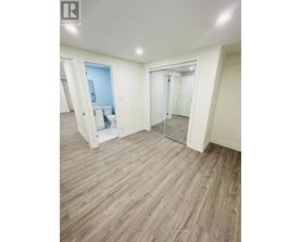 A room with a wooden floor and white walls.