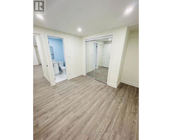 A room with a wooden floor and white walls.