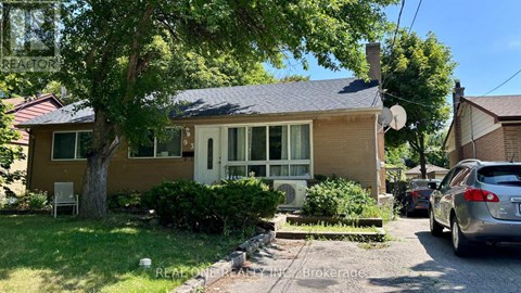 A house with a brown roof and a tree in front.