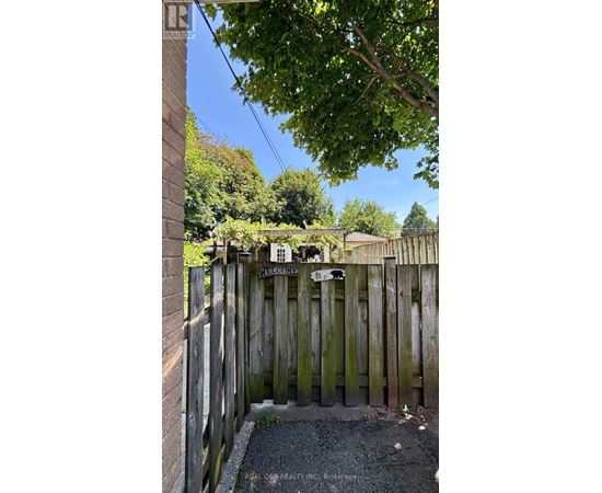 A wooden fence with a sign that reads "Welcome" on it.
