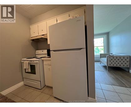A kitchen with a white refrigerator, oven, and microwave.