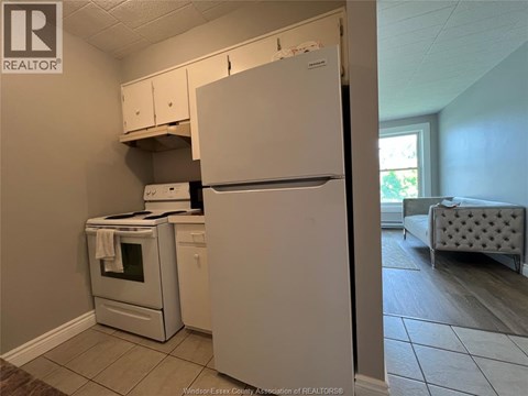 A kitchen with a white refrigerator, oven, and microwave.