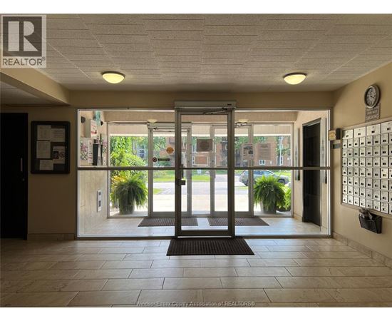The image shows the entrance to a building with a glass door and a sign that reads "REALTOR".