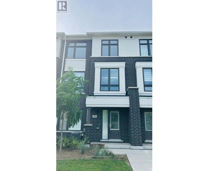 A modern two-story house with a black and white facade.