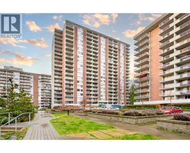 A modern apartment complex with a well-maintained outdoor area.