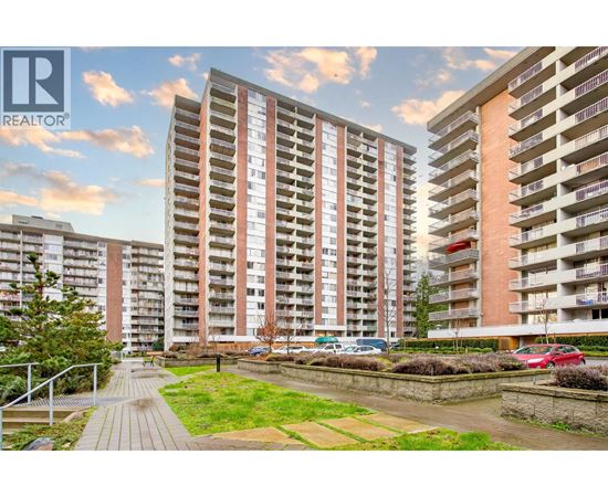 A modern apartment complex with a well-maintained outdoor area.