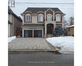 A brick house with a sign that says "Best Custom Craftsmen" in front of it.