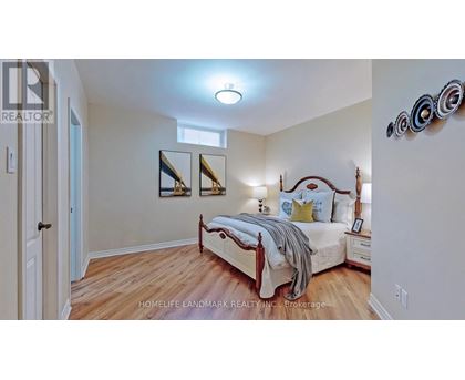 A bedroom with a bed, nightstands, and a mirror on the wall.