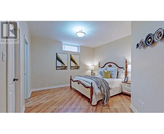 A bedroom with a bed, nightstands, and a mirror on the wall.
