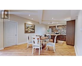 A dining room with a wooden table and chairs.