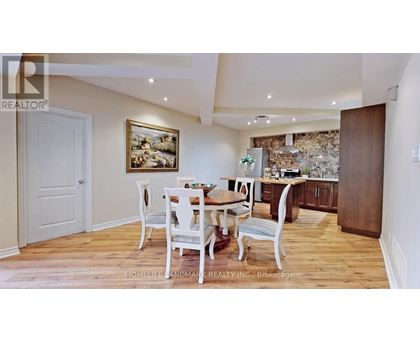 A dining room with a wooden table and chairs.