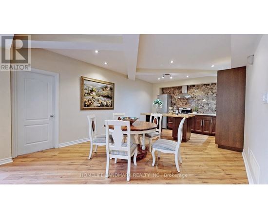 A dining room with a wooden table and chairs.