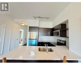 A kitchen with a sink and a counter.