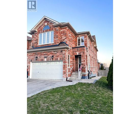 A red brick house with a white garage door.