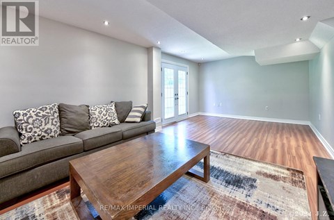 A living room with a grey couch and a wooden coffee table.