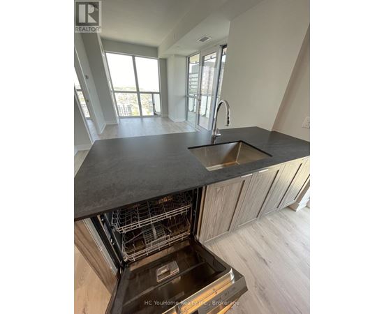 A modern kitchen with a sink and a dishwasher.