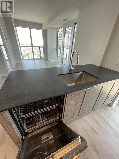 A modern kitchen with a sink and a dishwasher.