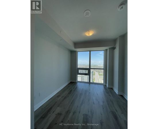 A spacious room with a view of the highway outside the window.