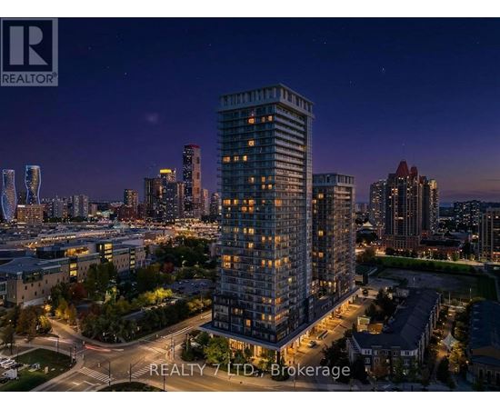 A nighttime cityscape with a tall building in the foreground and the REALTY 7 LTD. Brokerage logo in the bottom left corner.