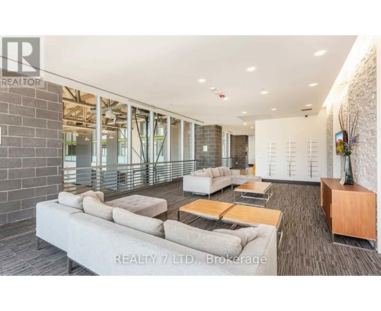 A spacious living room with a long couch and a coffee table.