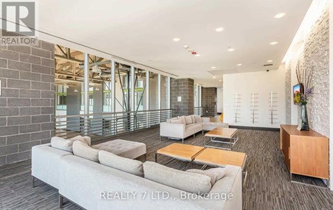 A spacious living room with a long couch and a coffee table.