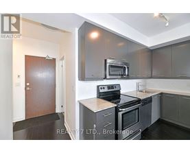 A modern kitchen with a stove top oven and microwave above it.