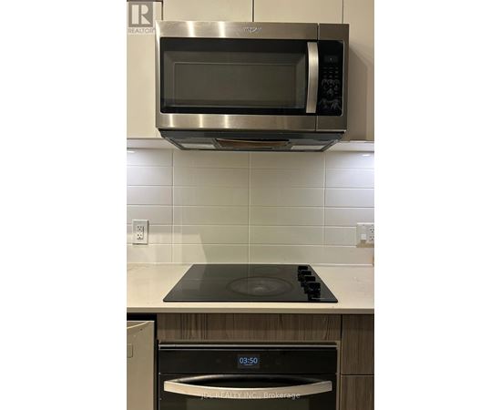 A stainless steel microwave oven mounted above a stove top.