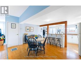 A dining room with a table and chairs.