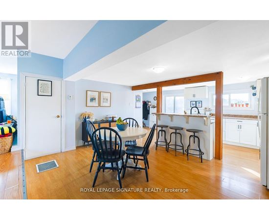 A dining room with a table and chairs.