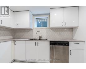 A kitchen with white cabinets and a stainless steel dishwasher.