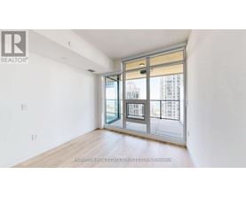 A white room with a sliding glass door leading to a balcony.