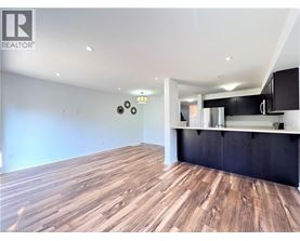 A room with wooden flooring and a black countertop.