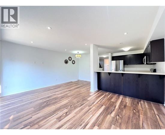 A room with wooden flooring and a black countertop.