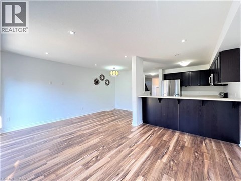 A room with wooden flooring and a black countertop.